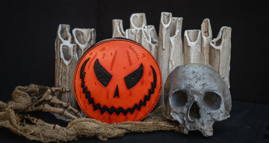 Halloween-themed purse with a jack-o'-lantern design on a dark background